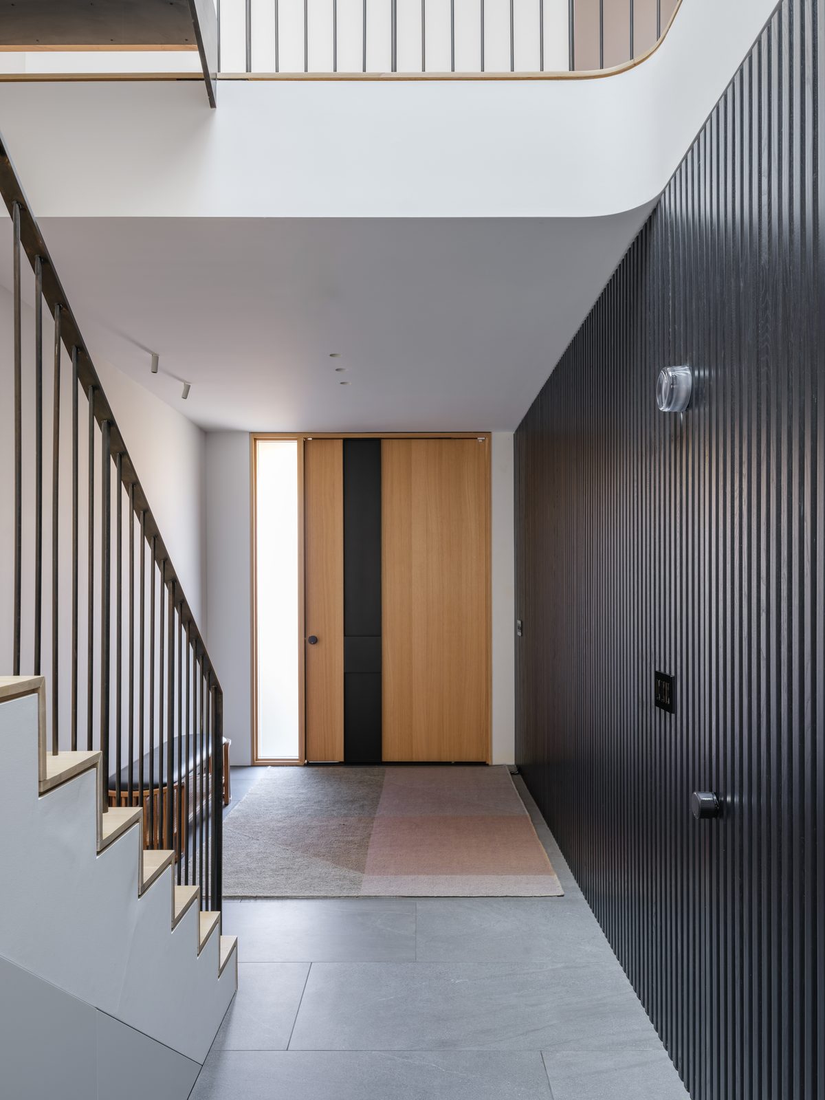 Entry hall with blackened vertical cladding