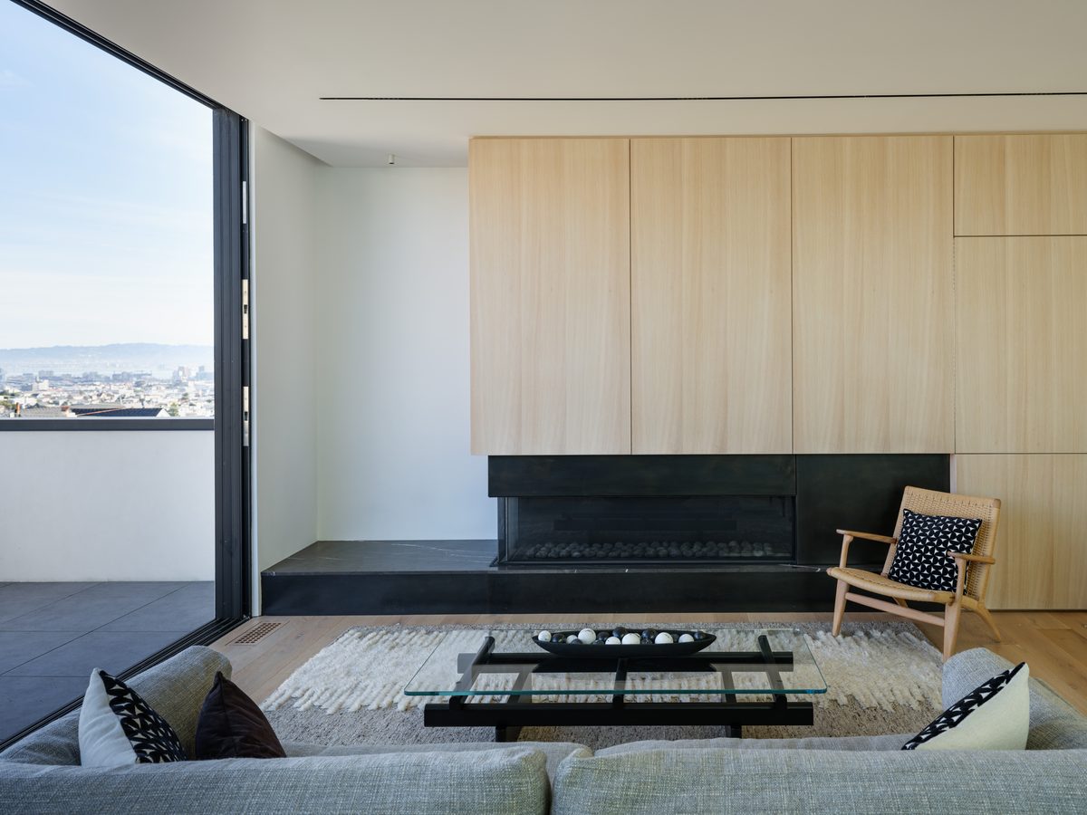 Blackened steel fireplace and oak wall